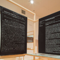 Hương Ngô and Hồng-Ân Trương, "AND AND AND – Stammering: An Interview", 2010–present, Wood, two-way mirrors, archival pigment prints on rice paper, archival documents, video monitor, books, framed certificate, With performance collaboration by "Black Lunch Table" (Heather Hart, Jina Valentine)