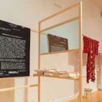Hương Ngô and Hồng-Ân Trương, "AND AND AND – Stammering: An Interview", 2010–present, Wood, two-way mirrors, archival pigment prints on rice paper, archival documents, video monitor, books, framed certificate, With performance collaboration by "Black Lunch Table" (Heather Hart, Jina Valentine)